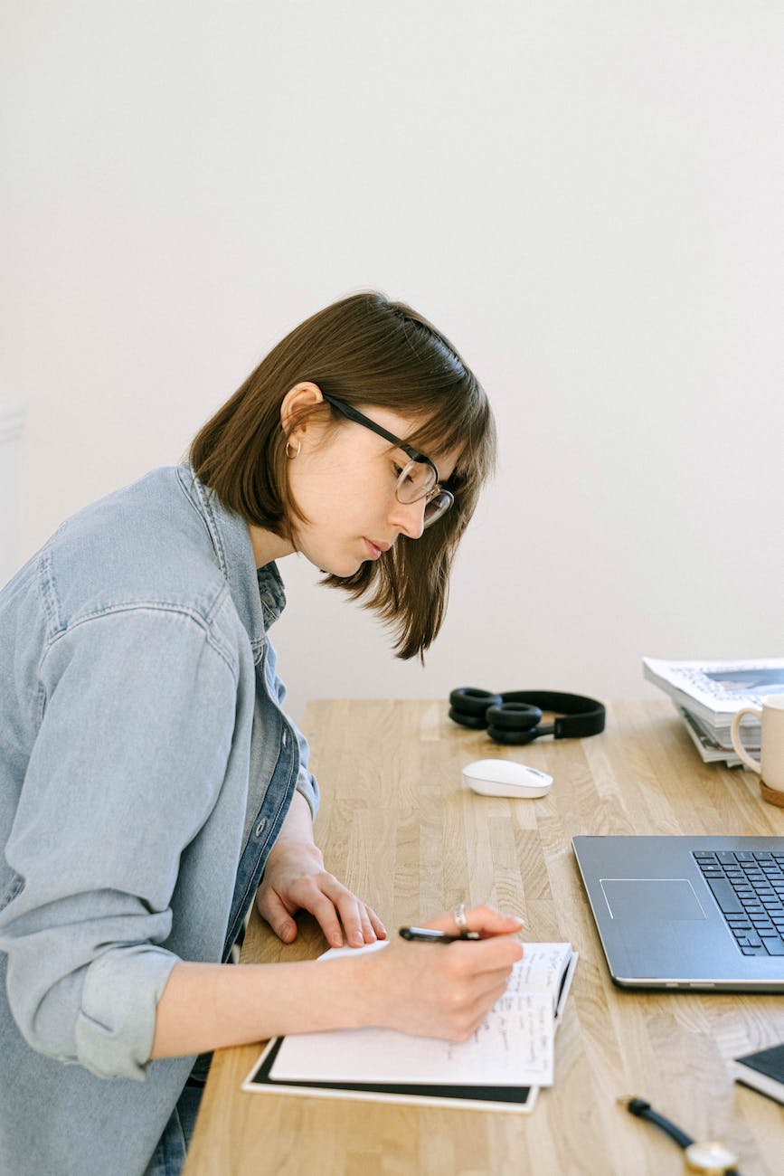 woman writing on a notebook